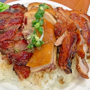 A mixed plate of chicken, pork and duck.